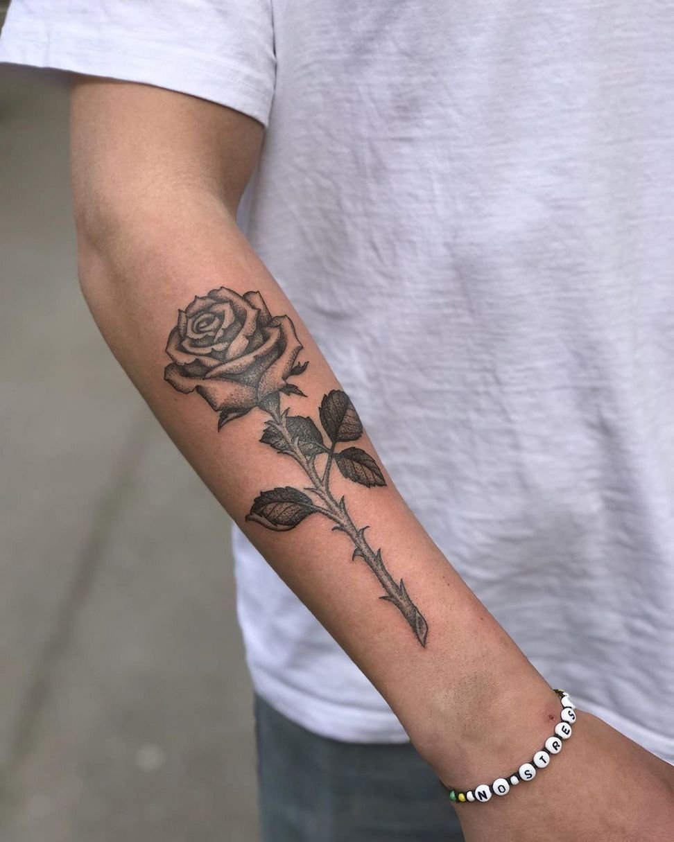 Tattoo of a rose on the forearm for men