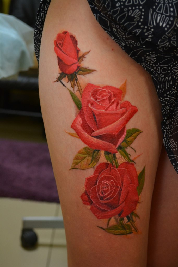 Colorful rose tattoo on the hip for women