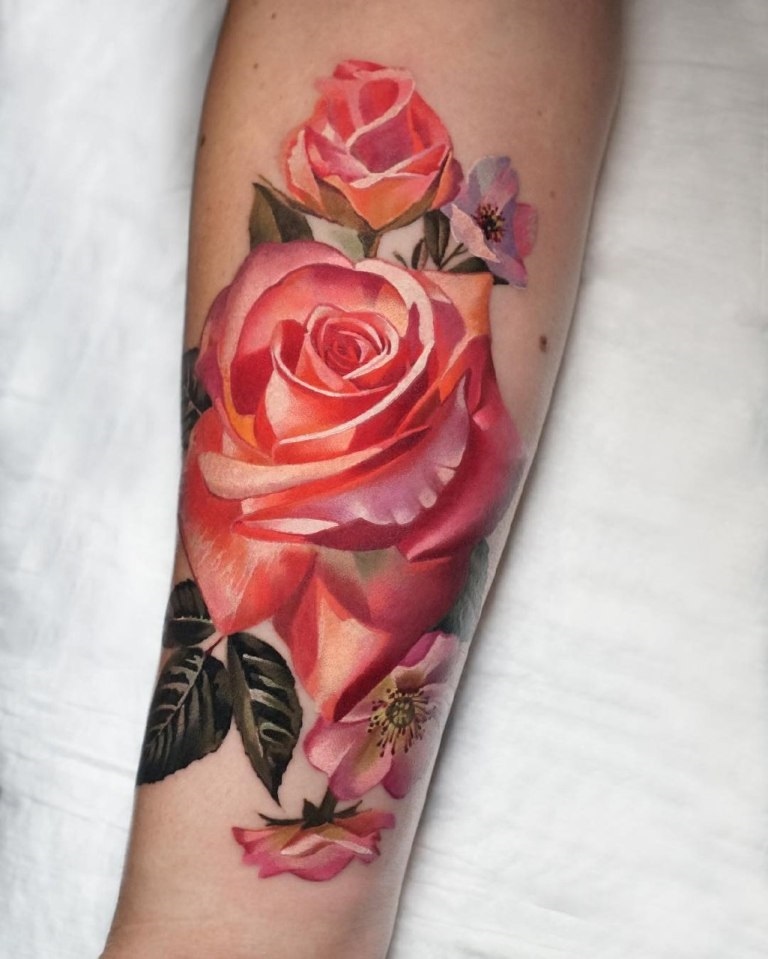 Colorful rose tattoo on the forearm for women