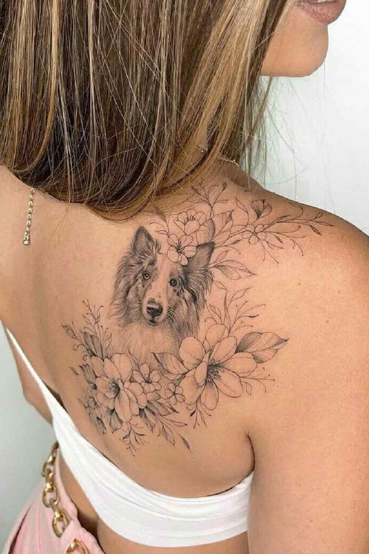 Tattoo of a dog on the shoulder blade for women