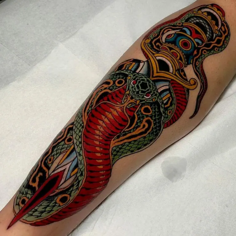 Tattoo of a colored cobra on the arm for women