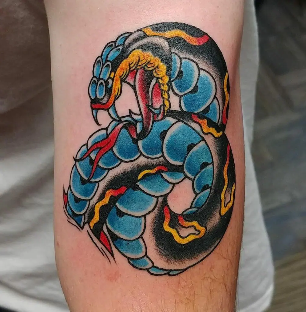 Tattoo of a colored cobra on the shoulder for men