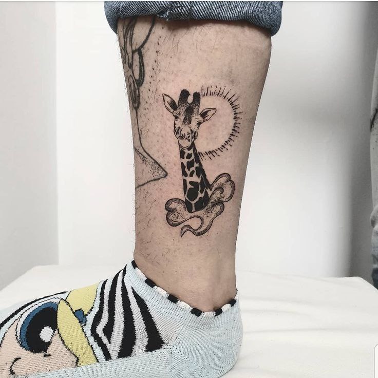 Tattoo of a giraffe on the shin for men