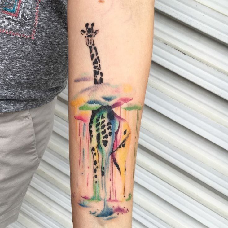 Color tattoo of a giraffe on the forearm for women