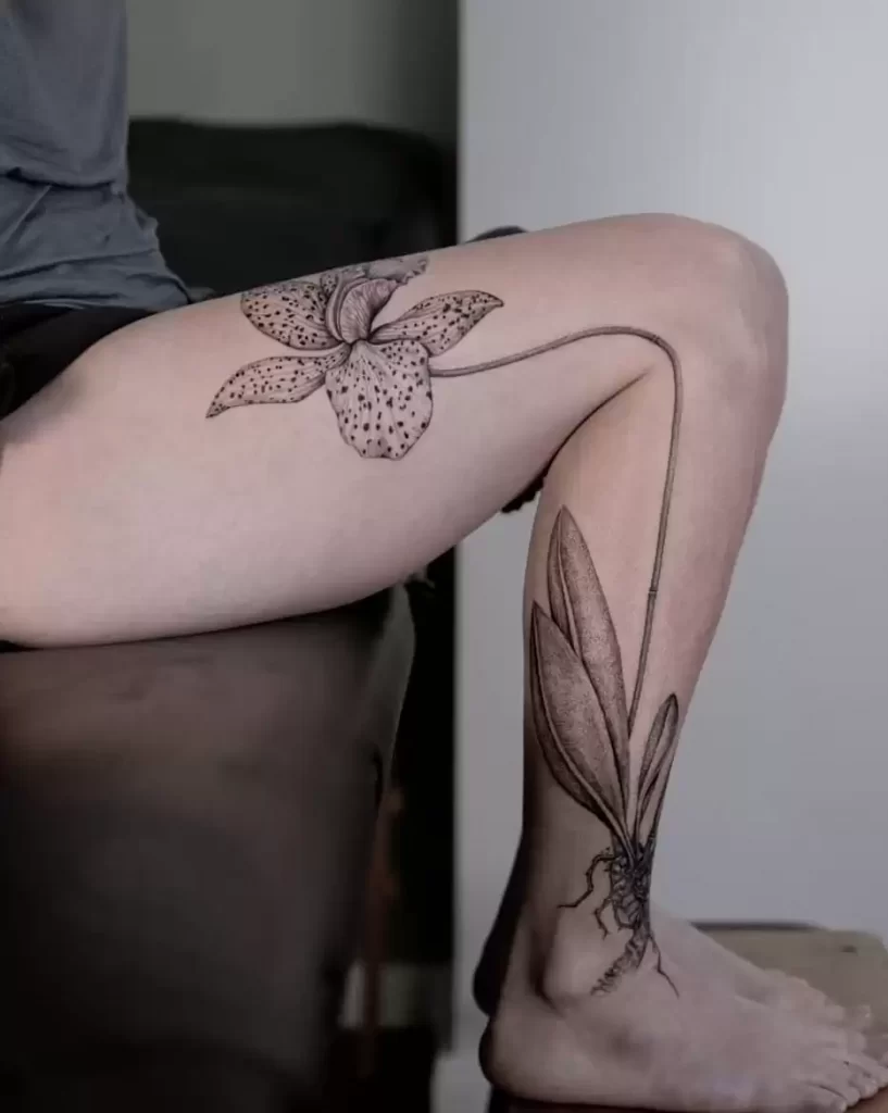 Large orchid tattoo on the leg for women