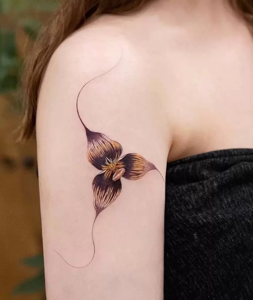 Color tattoo of an orchid on the shoulder for women