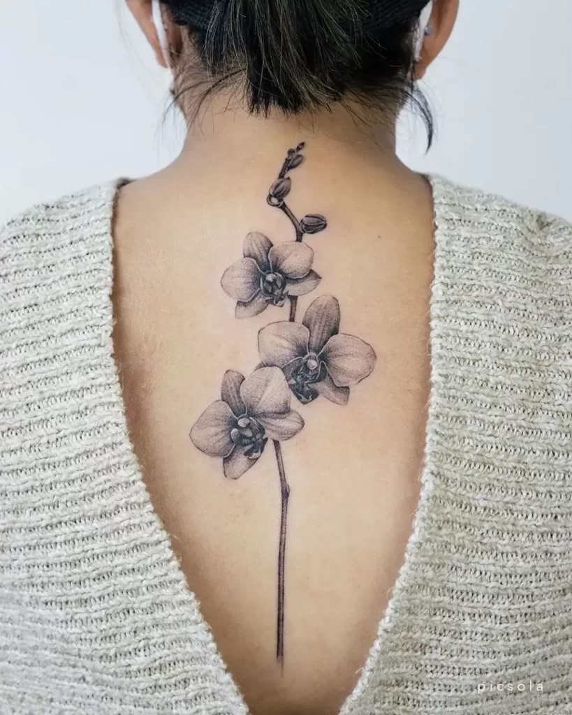 Orchid tattoo on the back for women