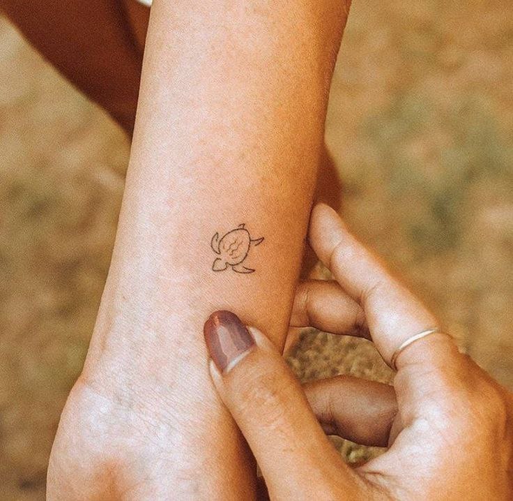 Turtle tattoo on the arm for women