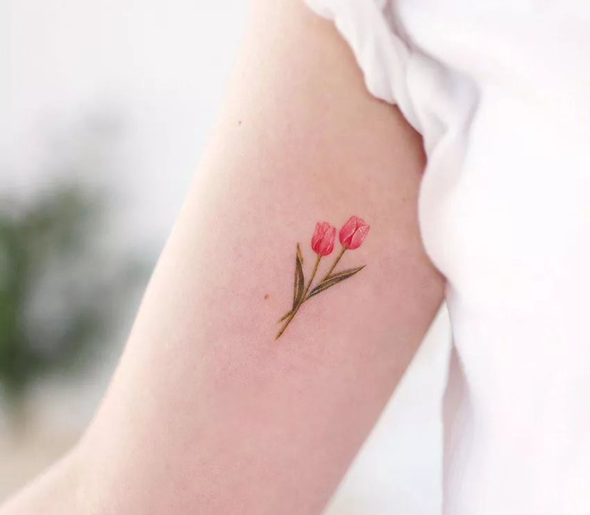 Small tulip tattoo on the shoulder for women