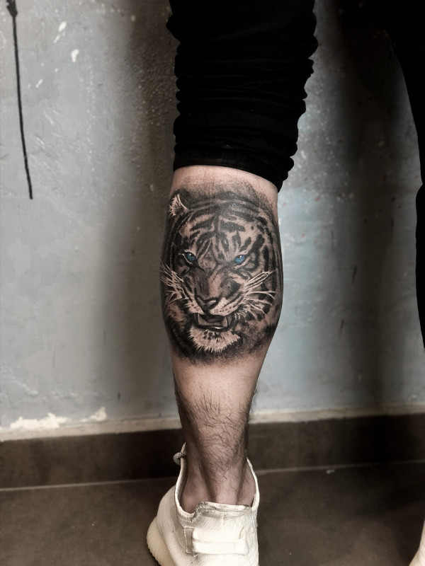 Tattoo of a tiger on a calf for men