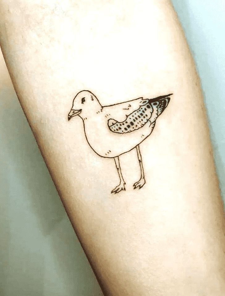 Tattoo of a seagull on the forearm for women