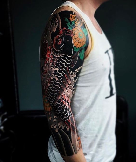 Color carp tattoo on the arm for men