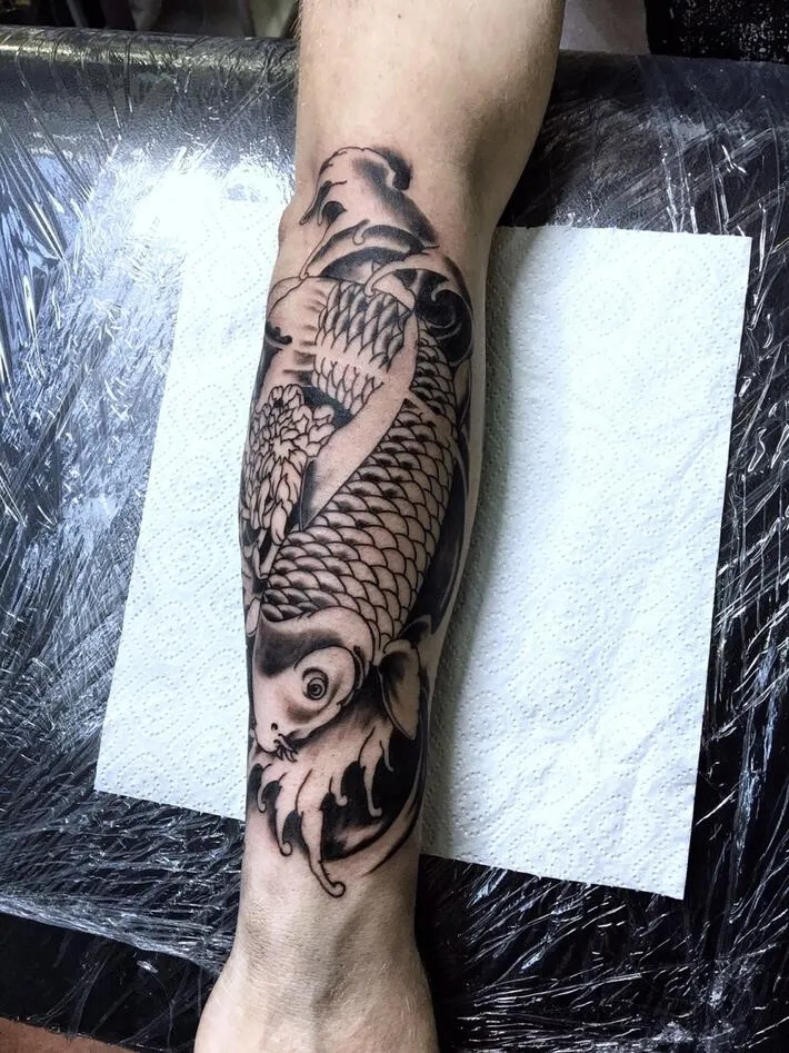 Large carp tattoo on the forearm for men