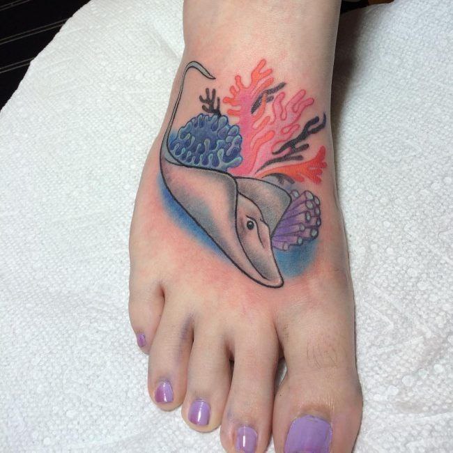 Colorful stingray tattoo on the ankle for women