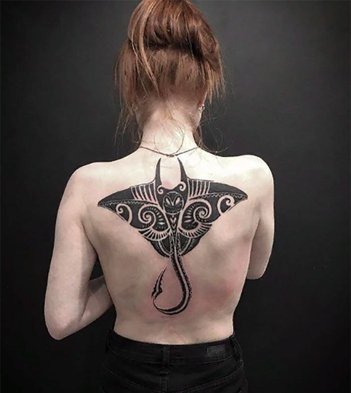 Large stingray tattoo on the back for women