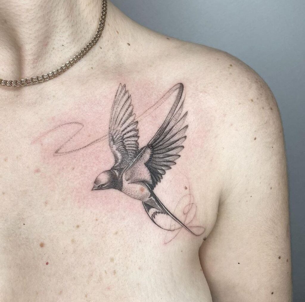 Large swallow tattoo on the collarbone for women