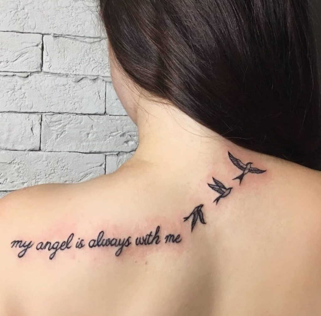 Small tattoo of three swallows with an inscription on the back for women