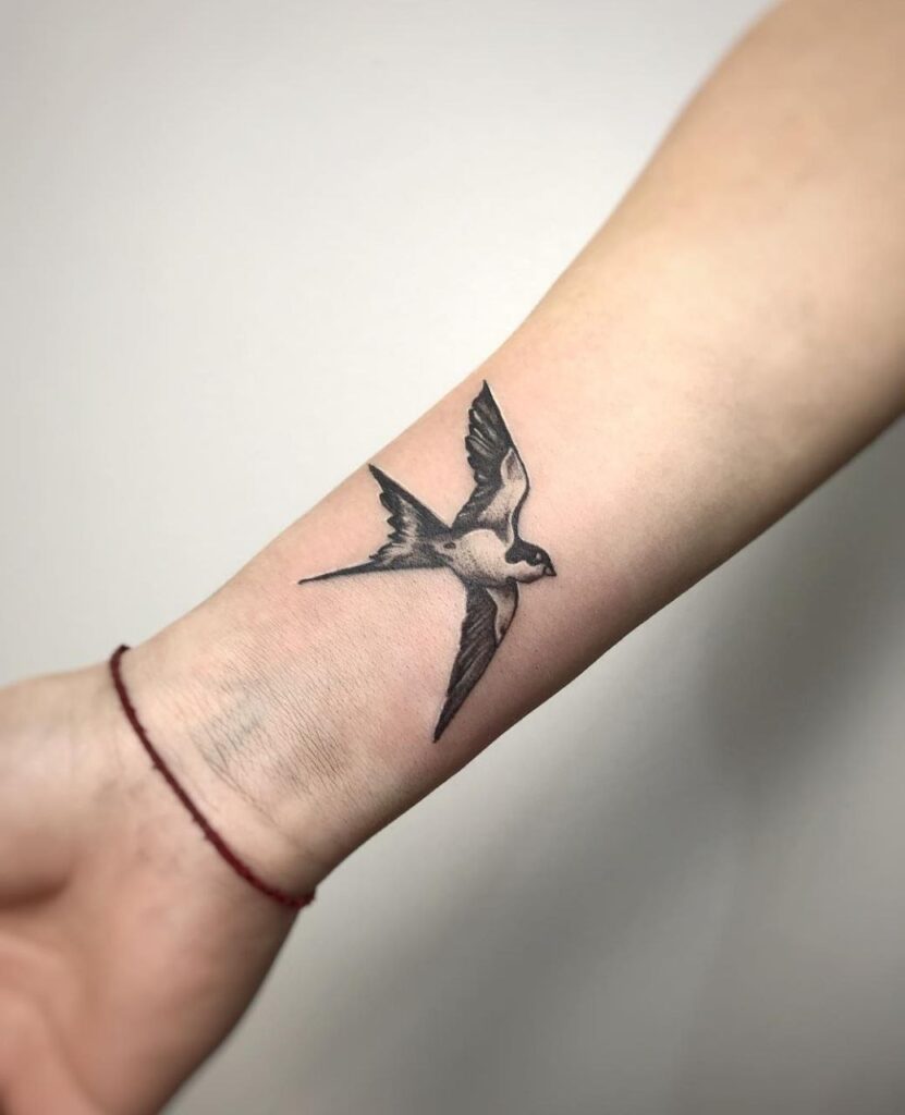 Swallow tattoo on forearm for women