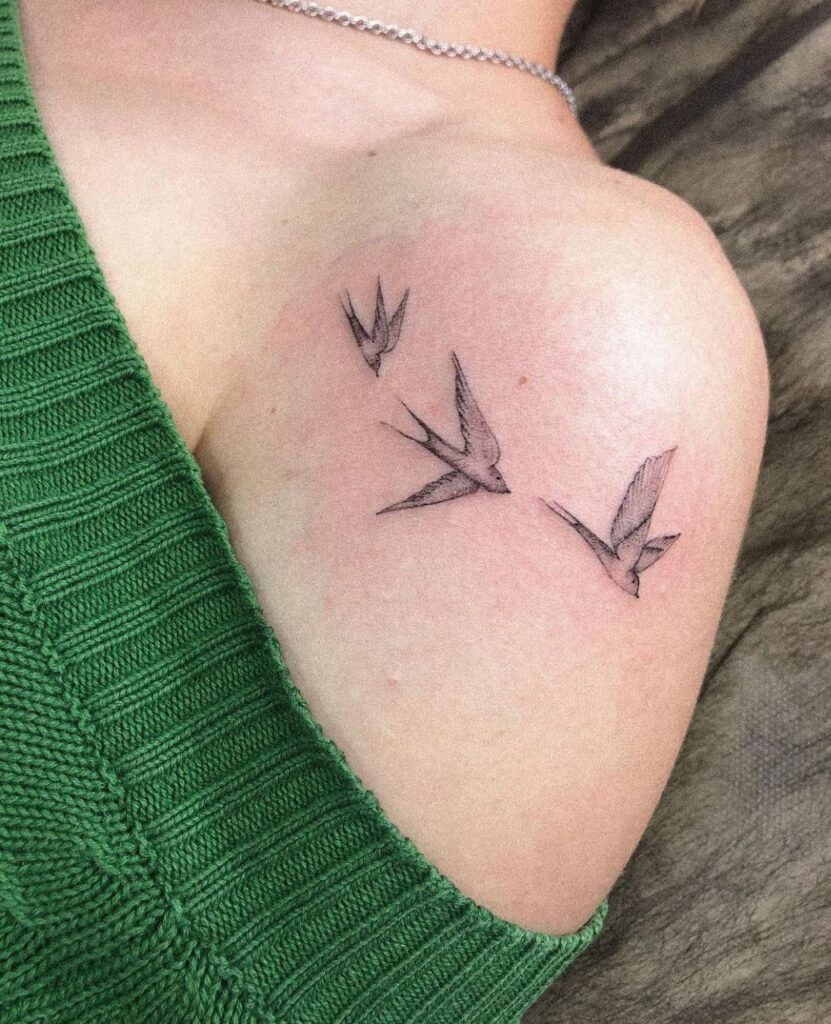 Small tattoo of three swallows on the shoulder for women