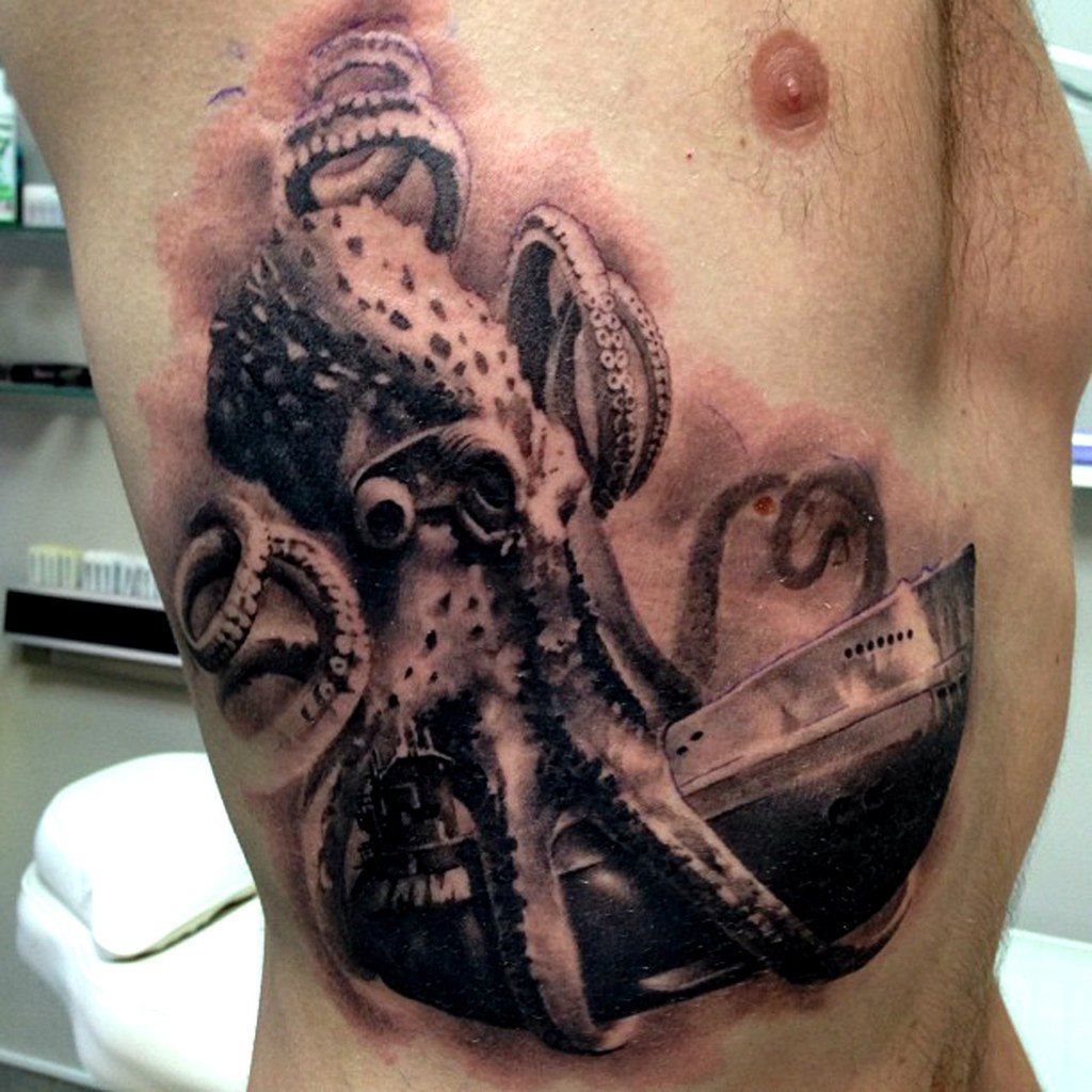 Large octopus tattoo with a ship on the side for men