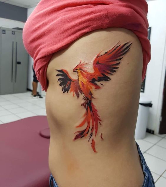 Colorful firebird tattoo on the side for women