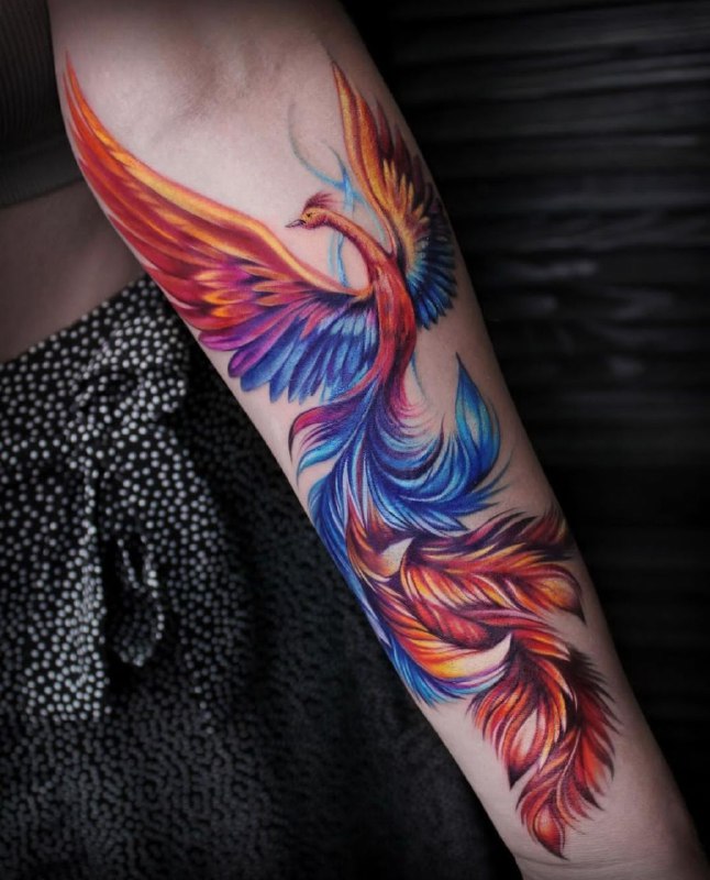 Big firebird tattoo on the forearm for women