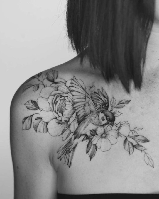 Tattoo of a sparrow with flowers on the collarbone for women