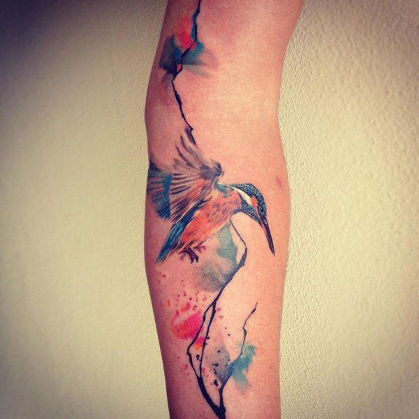 Colored hummingbird tattoo on the leg for women