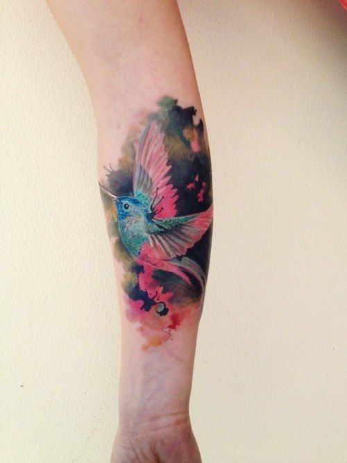 Colored hummingbird tattoo on the forearm for women