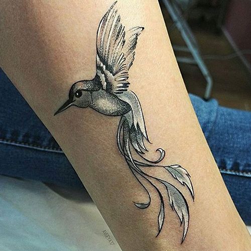 Colored hummingbird tattoo on the shin for women