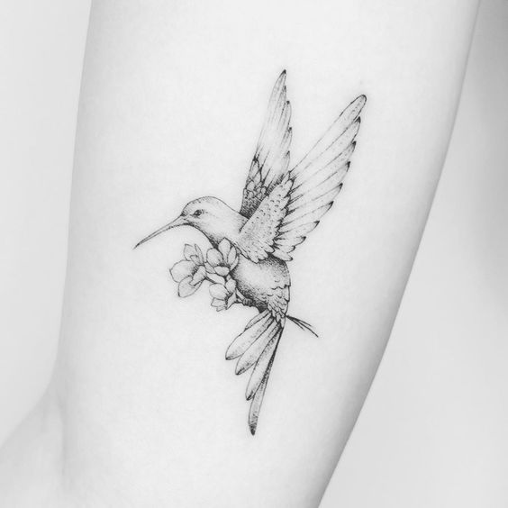 Large hummingbird tattoo on the arm for women