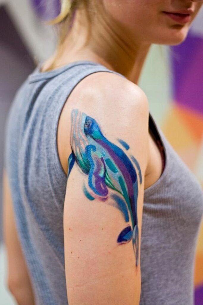 Large dolphin tattoo on the shoulder for women