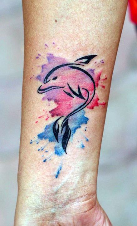 Colorful dolphin tattoo on the forearm for women