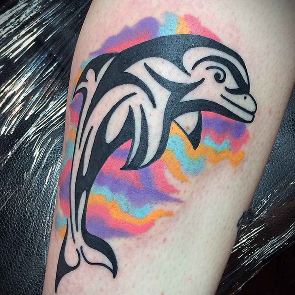 Colorful dolphin tattoo on the shin for women