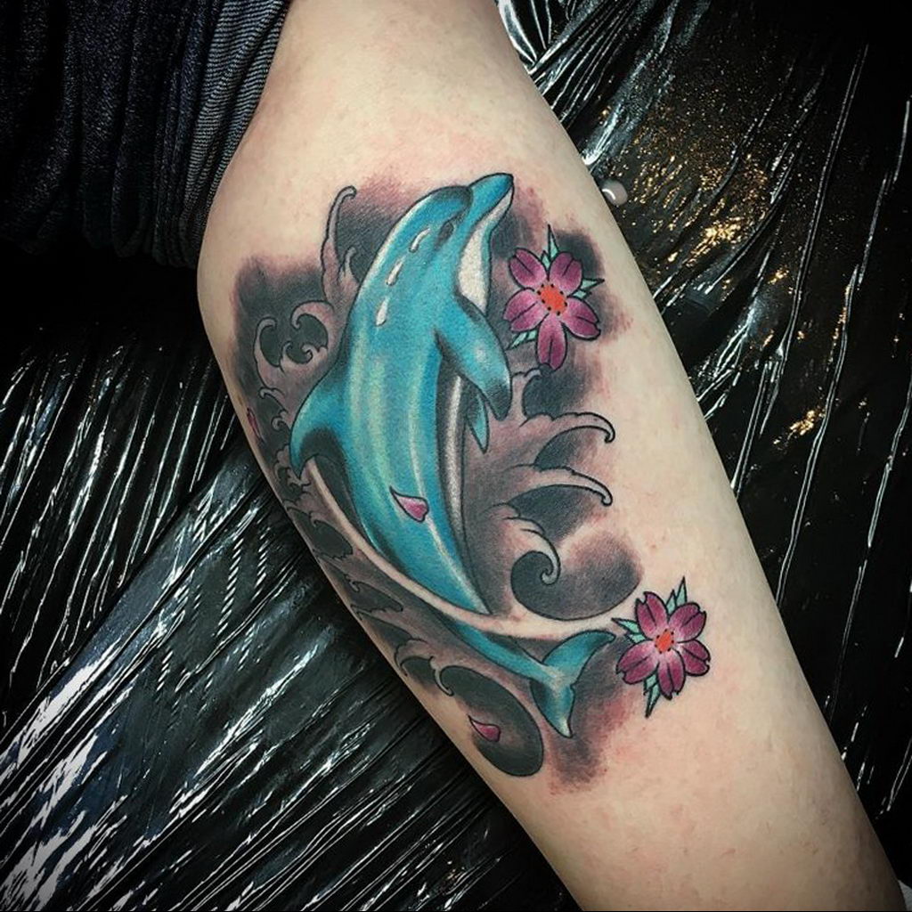 Colorful dolphin tattoo on the shoulder for women