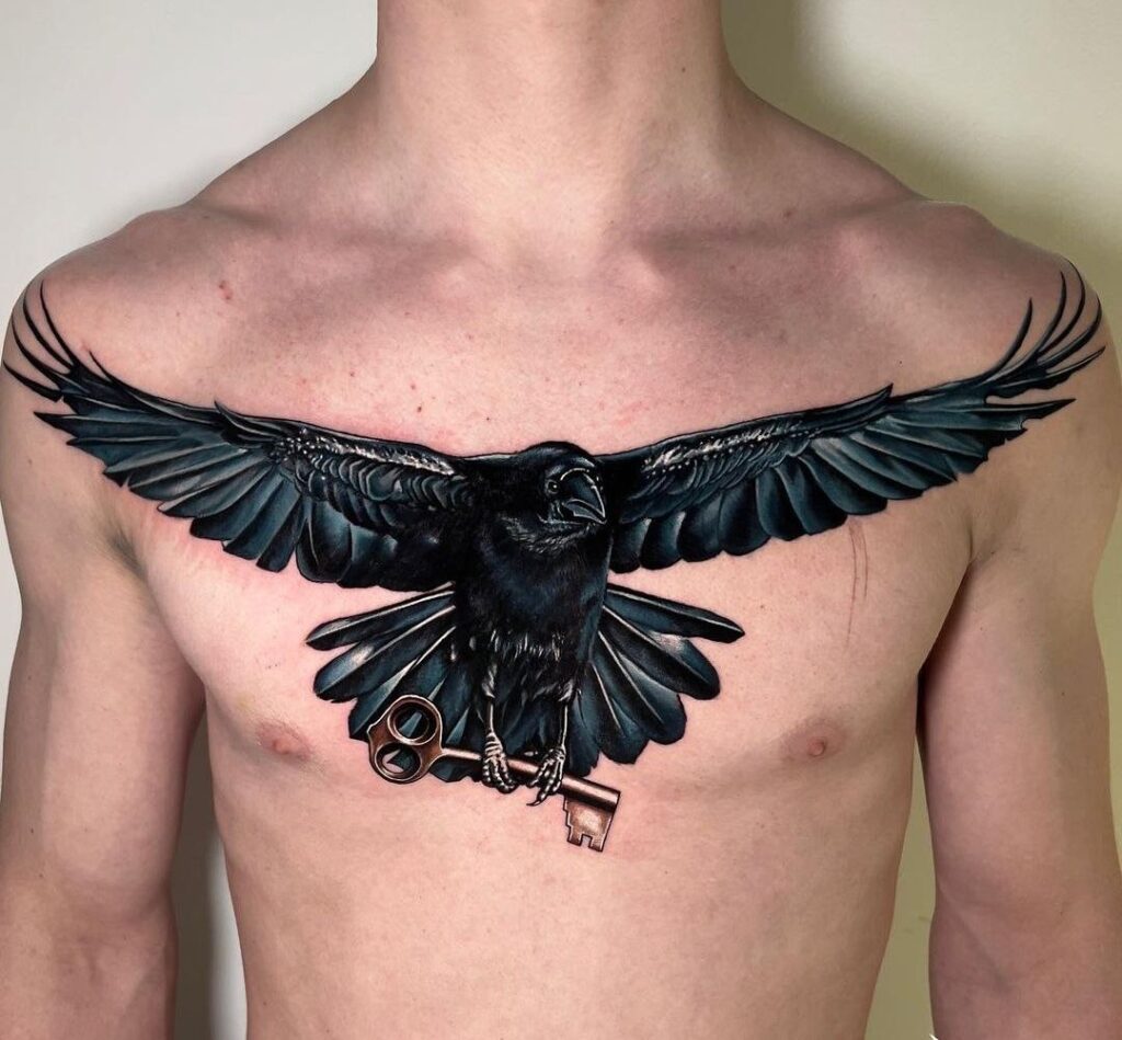 Large tattoo of a raven with a key on the chest for men