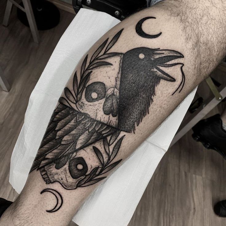 Large raven tattoo on the shin for men