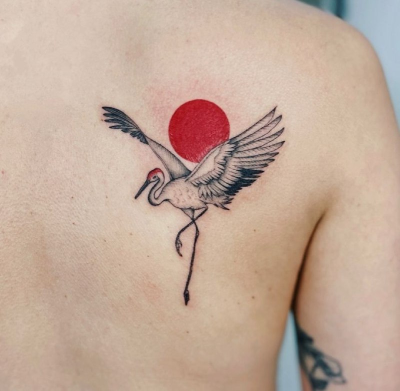 Colorful crane tattoo on the shoulder blade for men