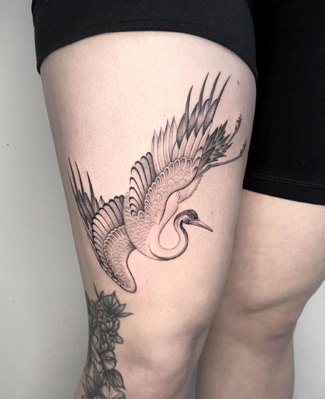 Crane tattoo on the thigh for women