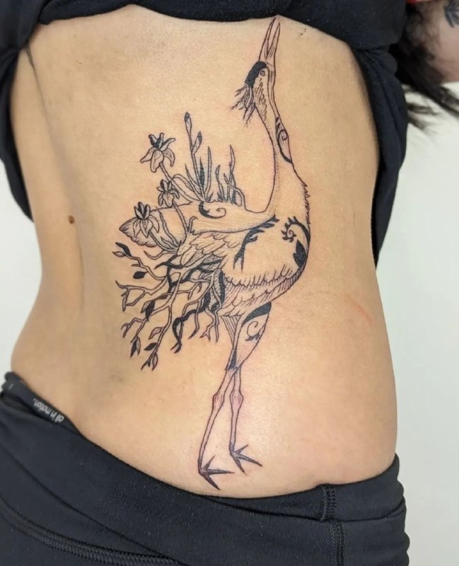 Large crane tattoo on the side for women