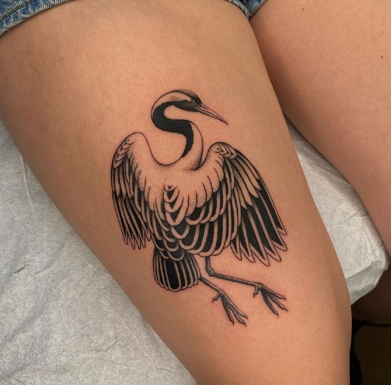 Large crane tattoo on the thigh for women