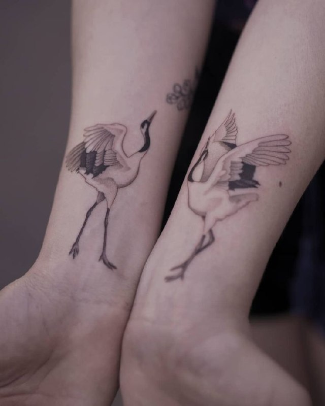 Tattoo of two cranes on hands for women