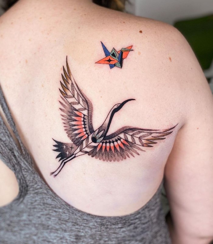 Colorful crane tattoo on the shoulder blade for women