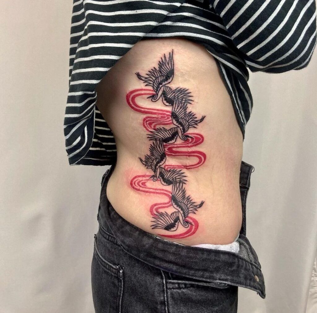 Colorful tattoo of four cranes on the side for women