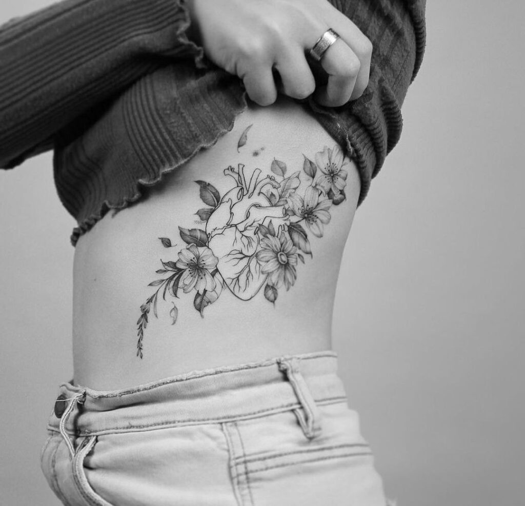 Heart and flowers tattoo on the side for women