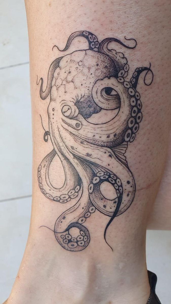 Large octopus tattoo on the shin for women