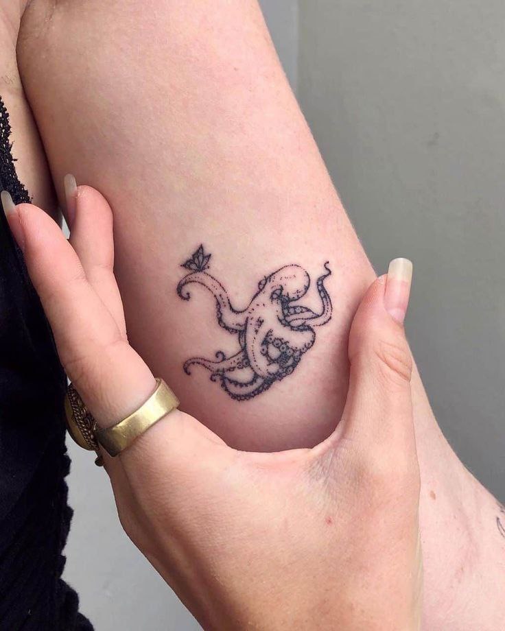 Small octopus tattoo on the shoulder for women