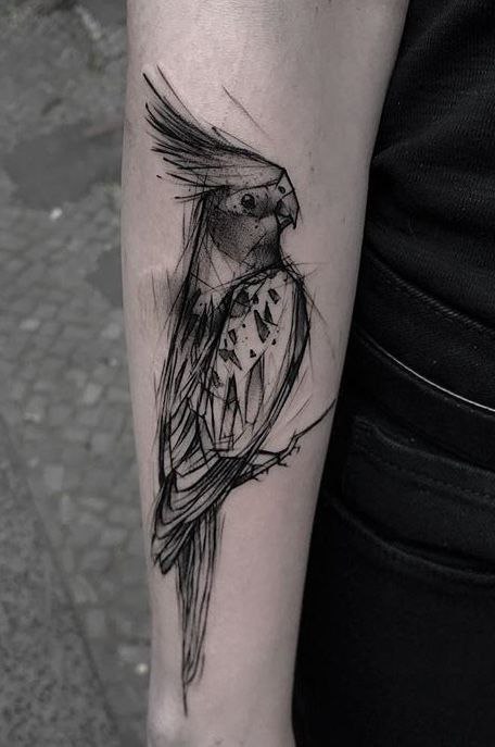 Large parrot tattoo on the forearm for men