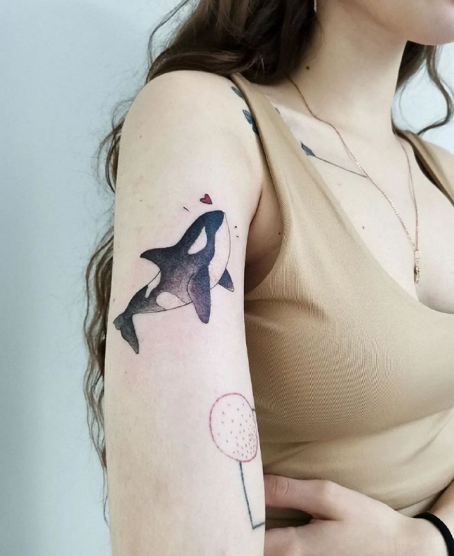 Orca tattoo on the shoulder for women