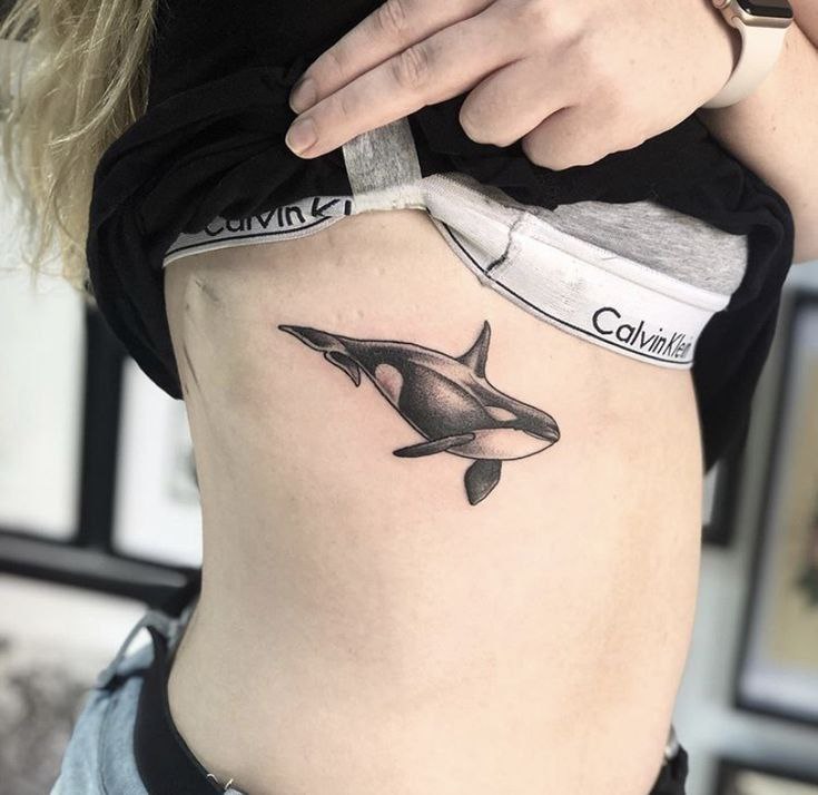 Orca tattoo on the side for women